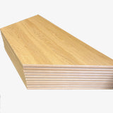 Stack of MDF edged trapezoidal oak table tops